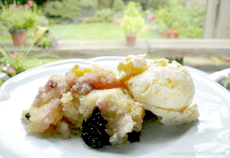 Delicious warm fruit cobbler topped with vanilla ice cream for a comforting dessert experience.