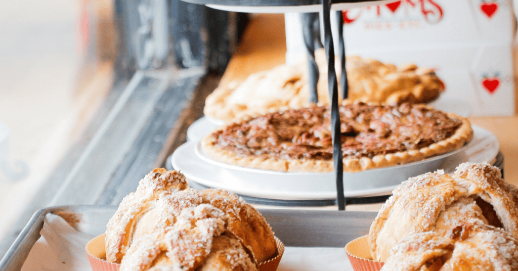 Tempting pastries and pecan pie arranged beautifully in a cozy bakery setting.