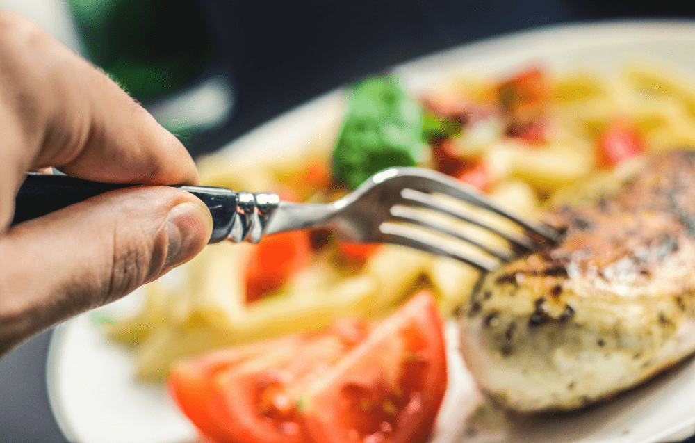 Delicious grilled chicken with fresh tomatoes and crispy fries for a satisfying meal.