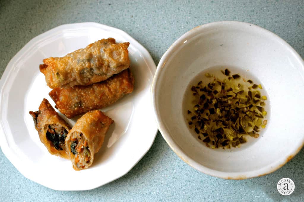 Homemade vegetarian spring rolls with crispy wonton wrappers and a savory vegetable filling with dipping sauce.