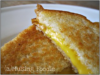 Deliciously melted cheese between crispy golden bread on a classic grilled cheese sandwich.