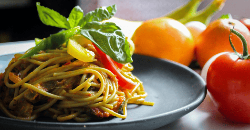 Delicious spaghetti tossed in vibrant vegetable sauce, perfect for a family meal.