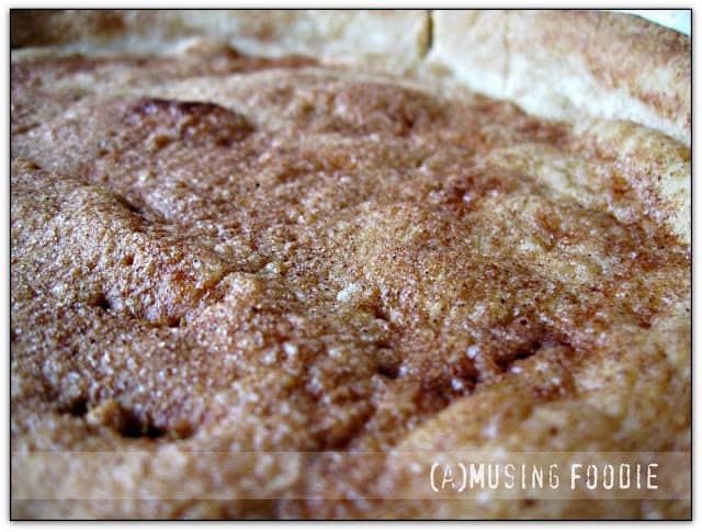 Golden apple cinnamon tart with a flaky crust, showcasing a rustic homemade dessert appeal.