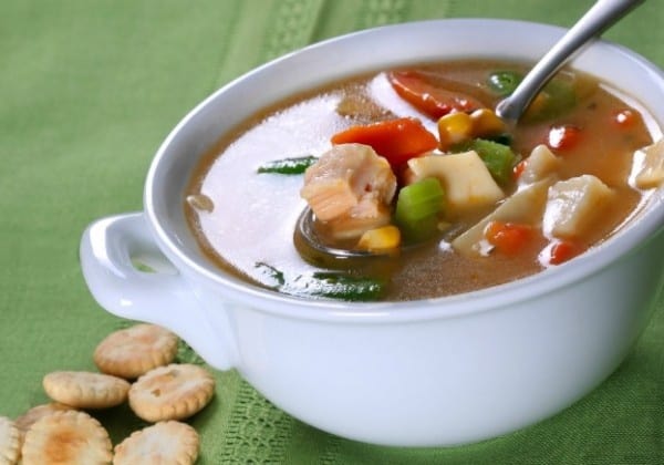 Delicious homemade chicken soup with fresh vegetables in a warm, inviting presentation.
