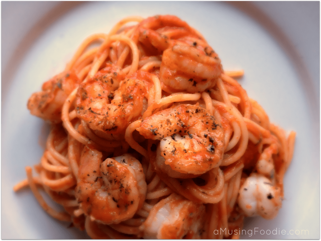 Delicious shrimp spaghetti in rich marinara sauce, elegantly presented for a gourmet dining experience.
