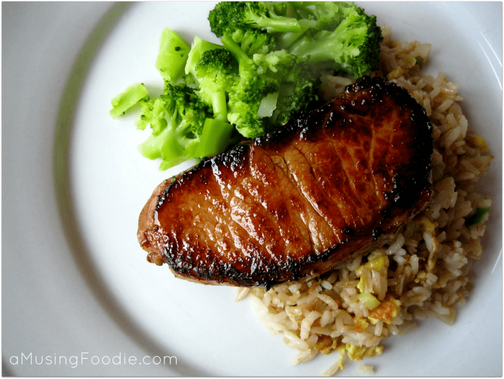 Teriyaki pork chops served with fried rice and steamed broccoli, a delicious meal option.