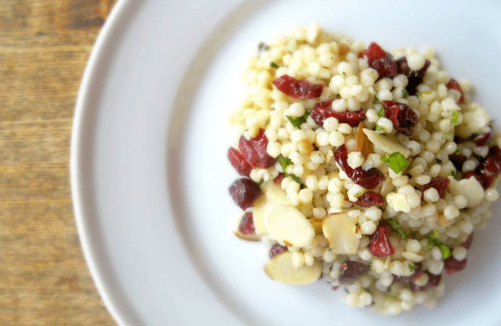 Delicious couscous salad with cranberries and almonds, perfect for summer picnics and barbecues.