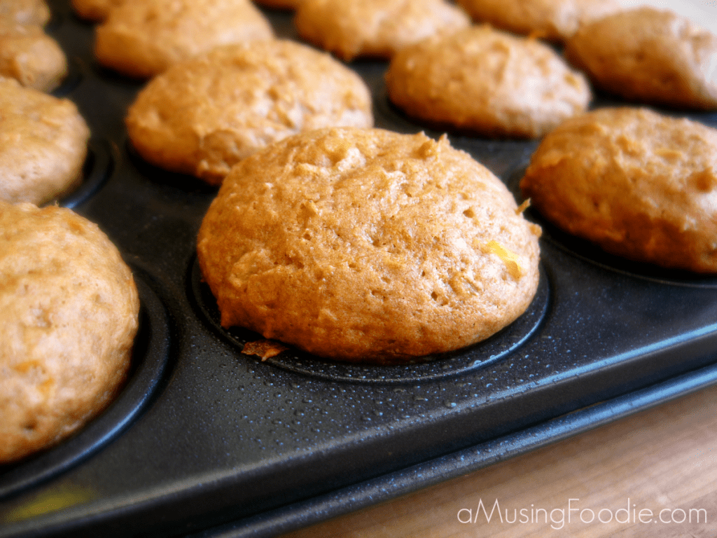 Freshly baked egg-free zucchini mini muffins, golden brown with a moist, fluffy texture.