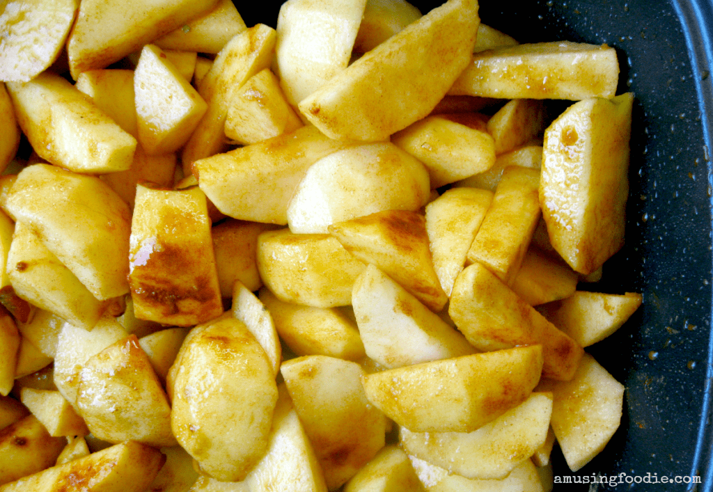 Crispy golden-brown potato wedges served in a dark bowl, perfect as a snack or side dish.