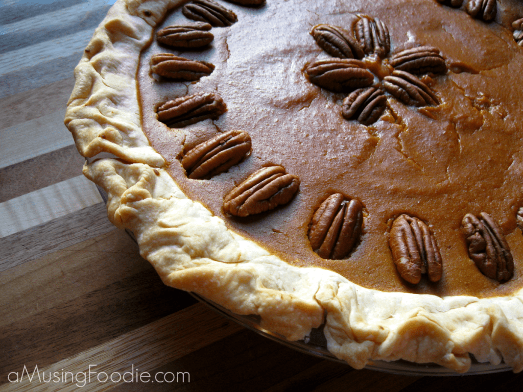 Diabetic-friendly pumpkin pie topped with pecans, perfect for fall gatherings and celebrations.