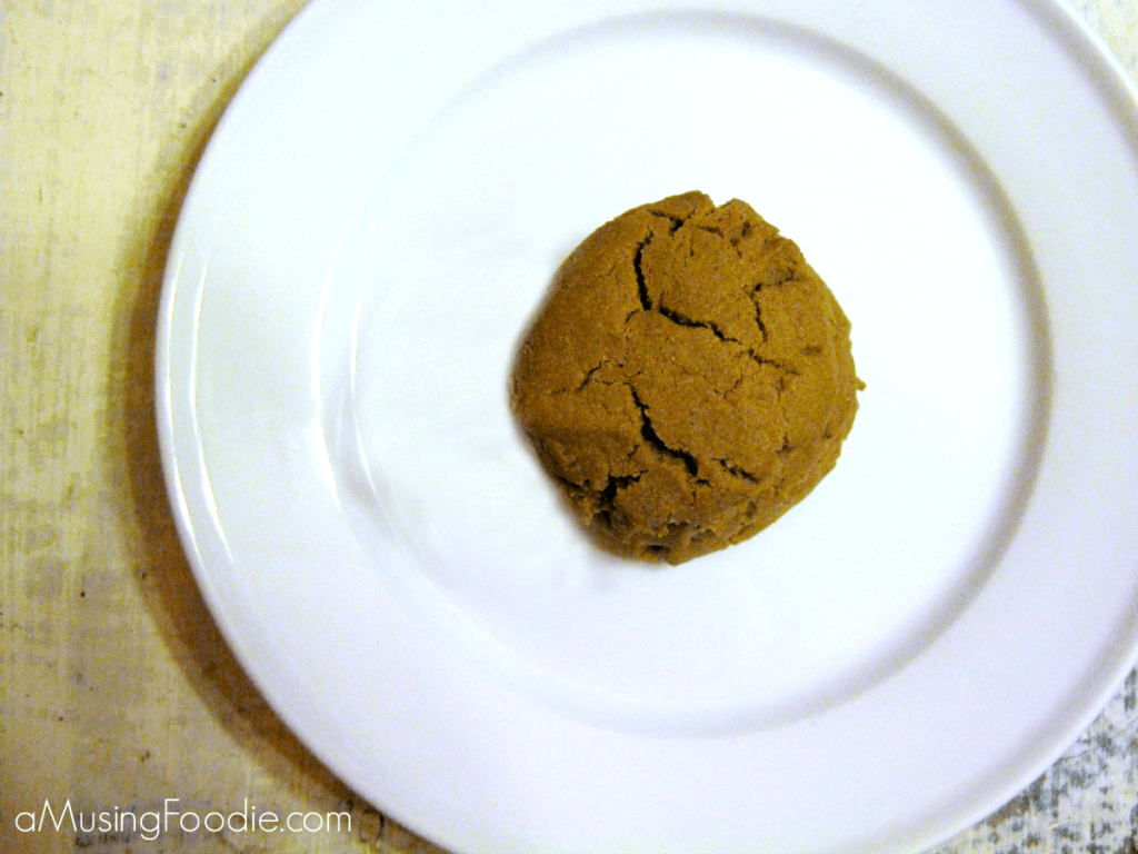 Freshly baked chocolate sugar cookie on a minimalist white plate for a cozy treat.