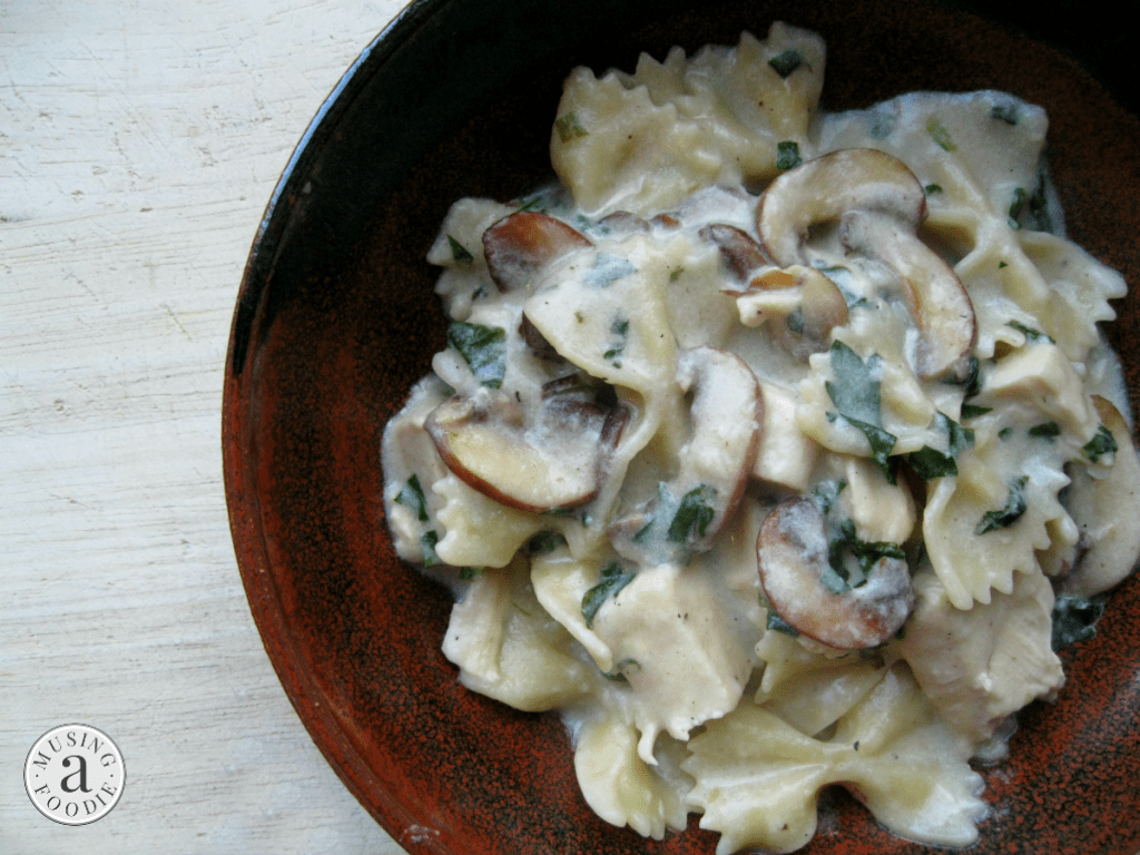 Creamy mushroom farfalle pasta in a rustic dish, perfect for a cozy weeknight dinner.