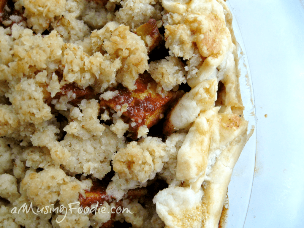 Rustic apple pie with a crumbly streusel topping, evoking warmth and homemade sweetness.