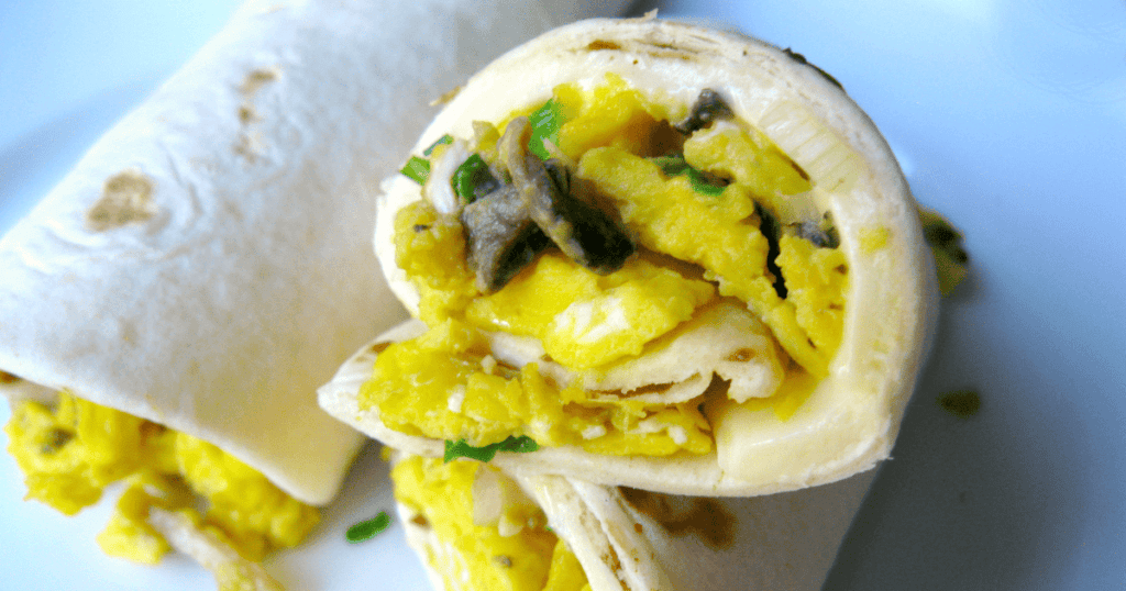Fluffy scrambled eggs and herbs wrapped in a warm, golden breakfast burrito.