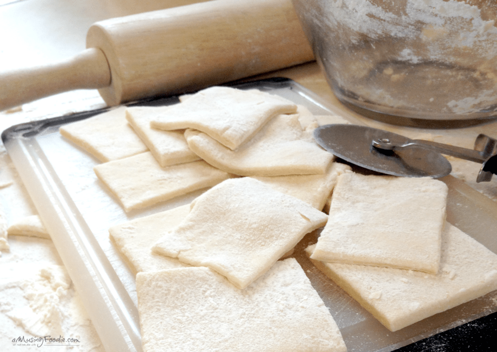 Rustic kitchen scene with dough preparation, tools, and ingredients for homemade baking delights.