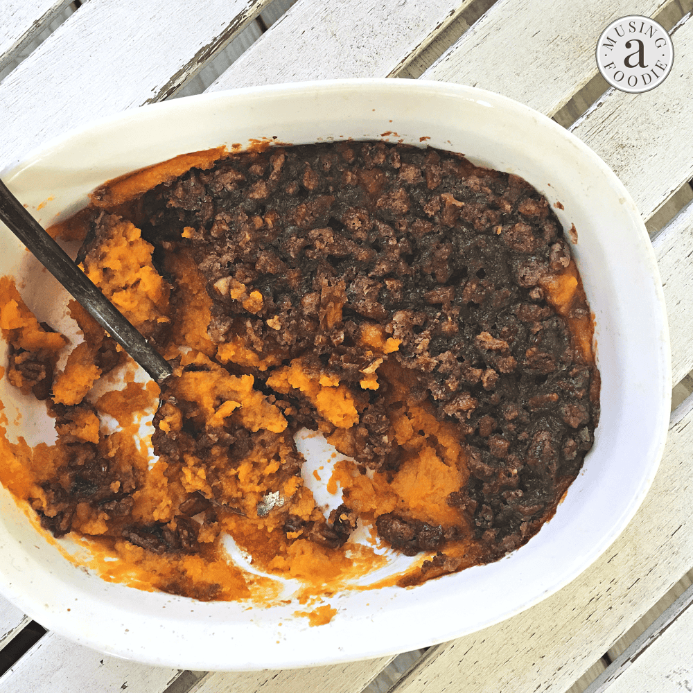 Irresistible sweet potato casserole with a crunchy nut topping, perfect for comfort food lovers.