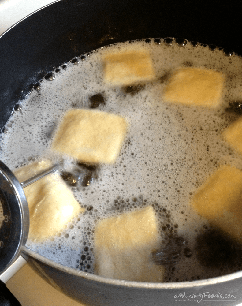 Golden dough squares boiling in a cozy kitchen, evoking warmth and comfort.
