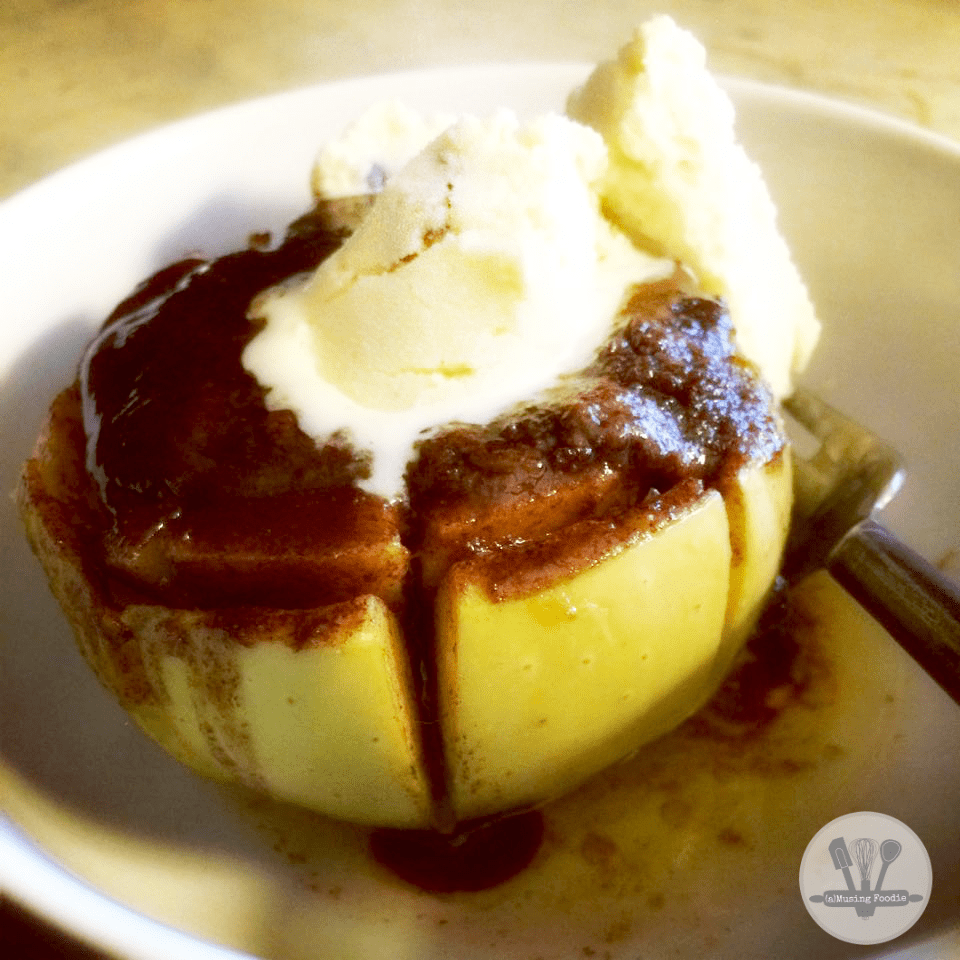 Irresistible baked apple dessert topped with creamy vanilla ice cream and drizzled with sauce.