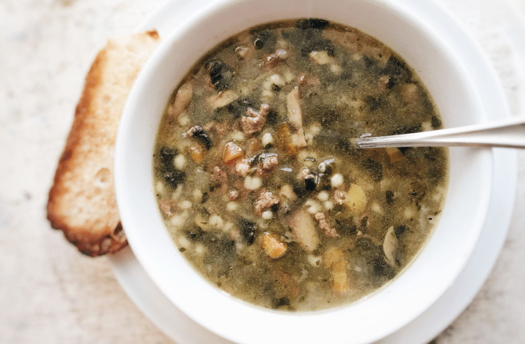 Delicious beef vegetable soup served with toasted bread for a comforting meal experience.