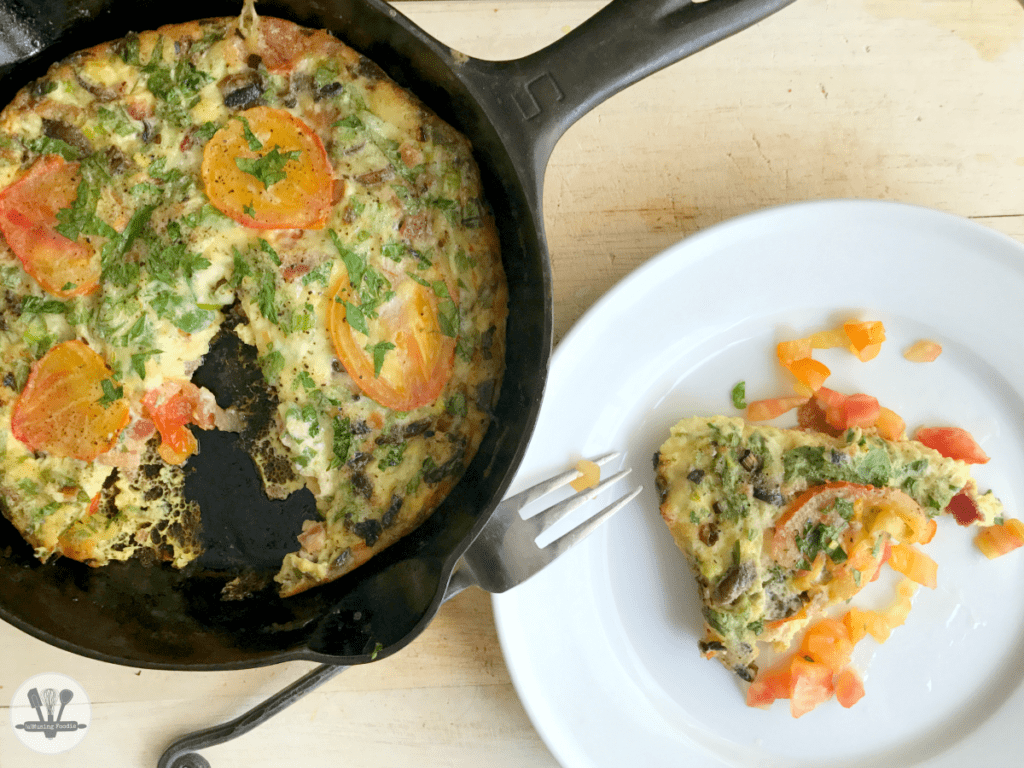 Colorful vegetable frittata in a cast iron skillet, perfect for brunch or a light dinner.