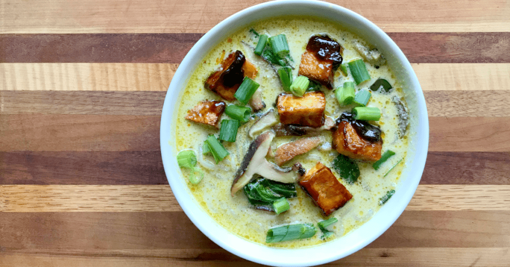 Delicious hearty vegan soup with crispy tofu, fresh veggies, and creamy broth, perfect for comfort.