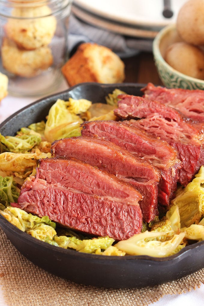 Sliced corned beef with cabbage in a skillet, perfect for any cozy gathering.