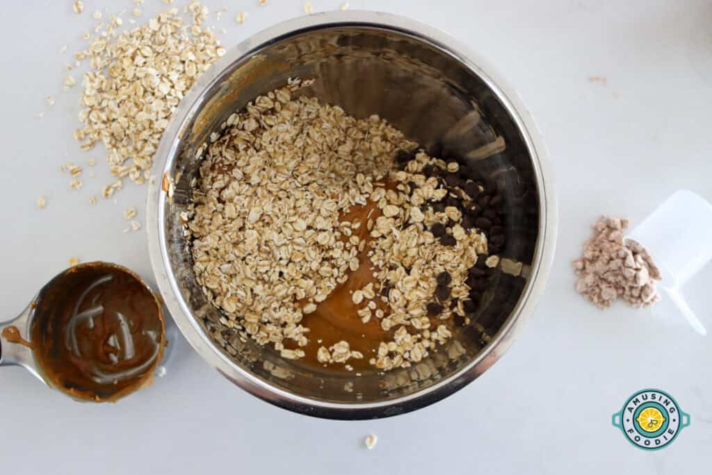 No-bake protein ball mixture in bowl with oats