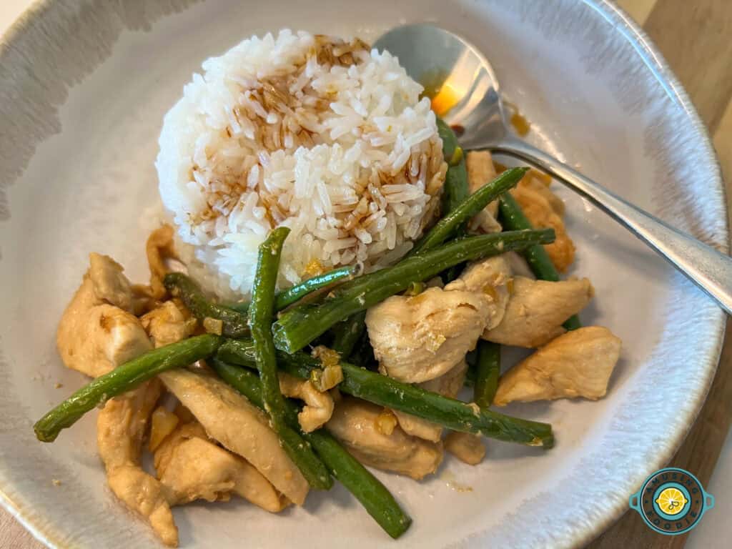 Wok Fried Green Beans & Chicken with rice drizzled with sauce