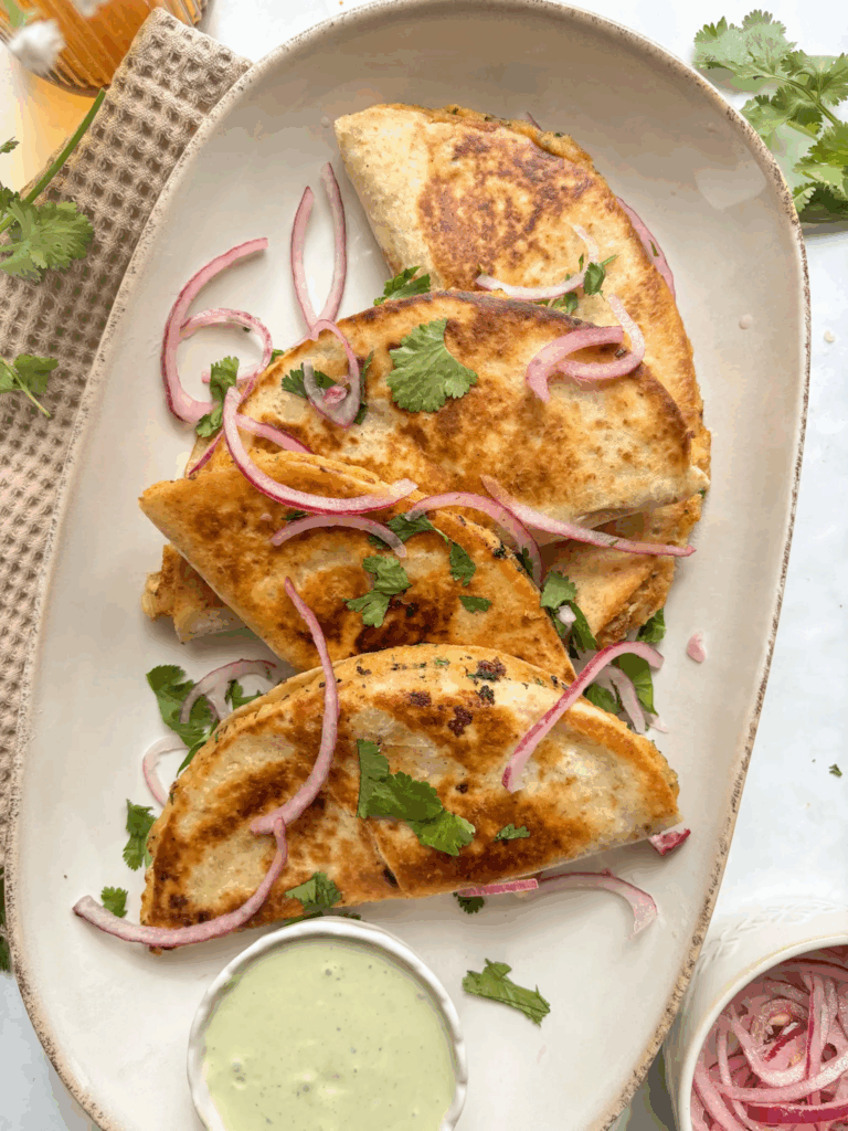 Potato Tacos sprinkled with onion and parsley with dip