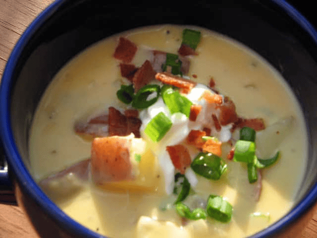 Cheesy Potato Soup with Bacon in a blue bowl