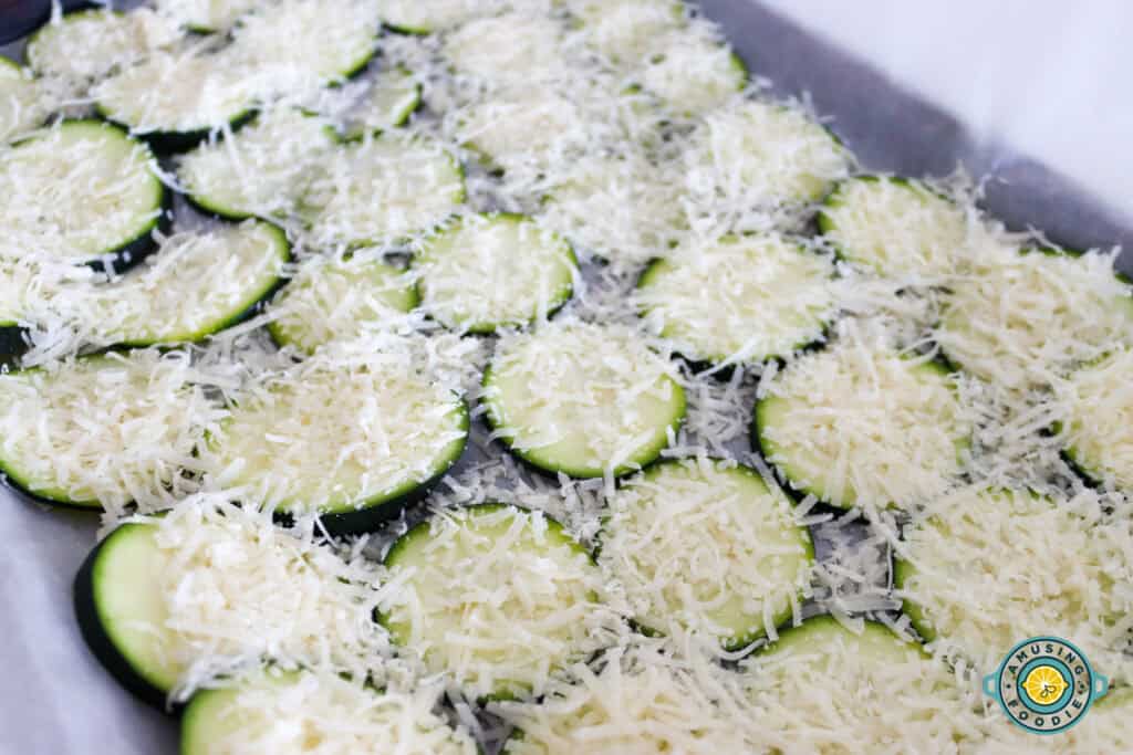 Cucumber sprinkled with parmesan on a pan