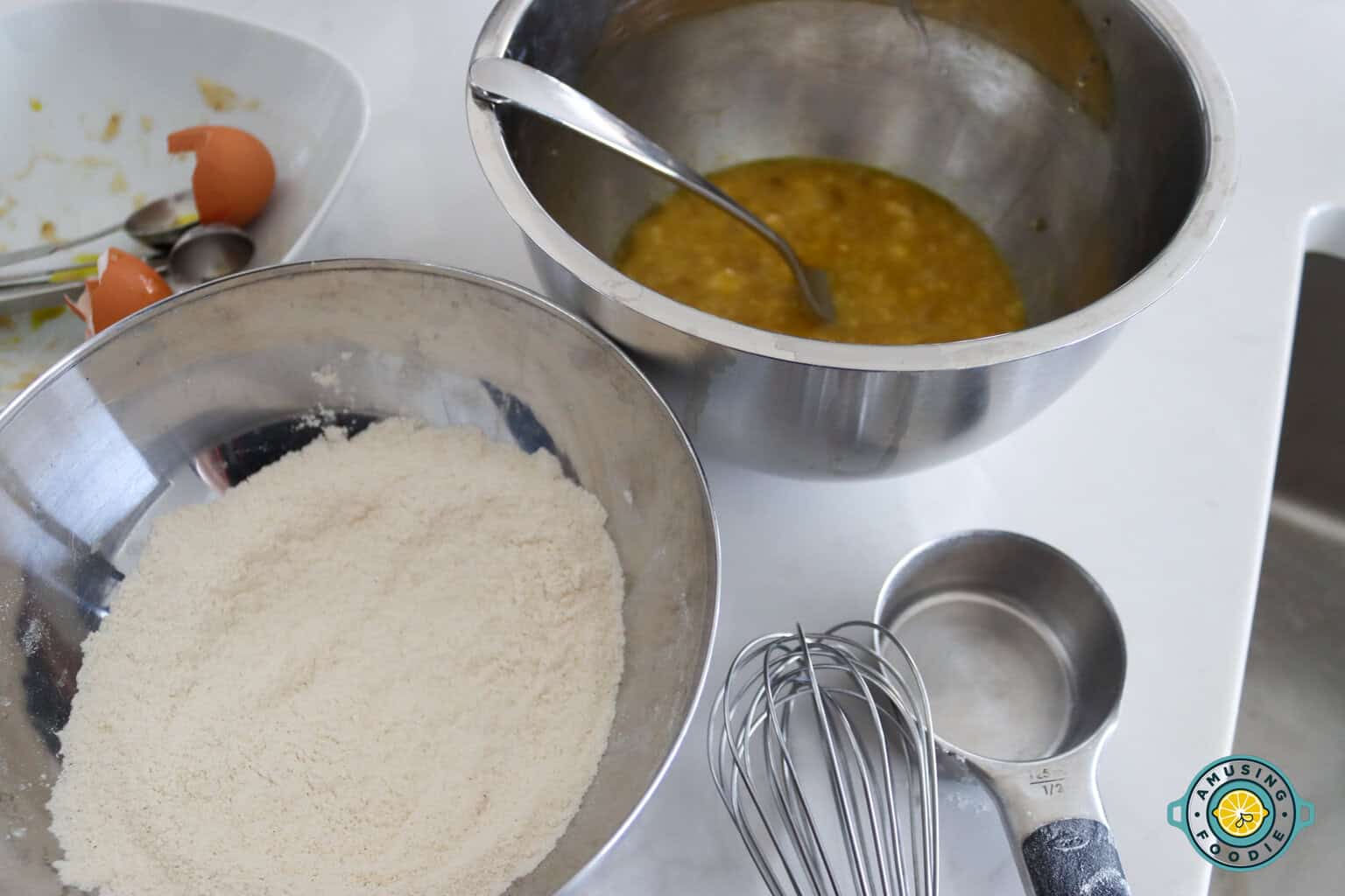 Banana muffin ingredients in mixing bowls