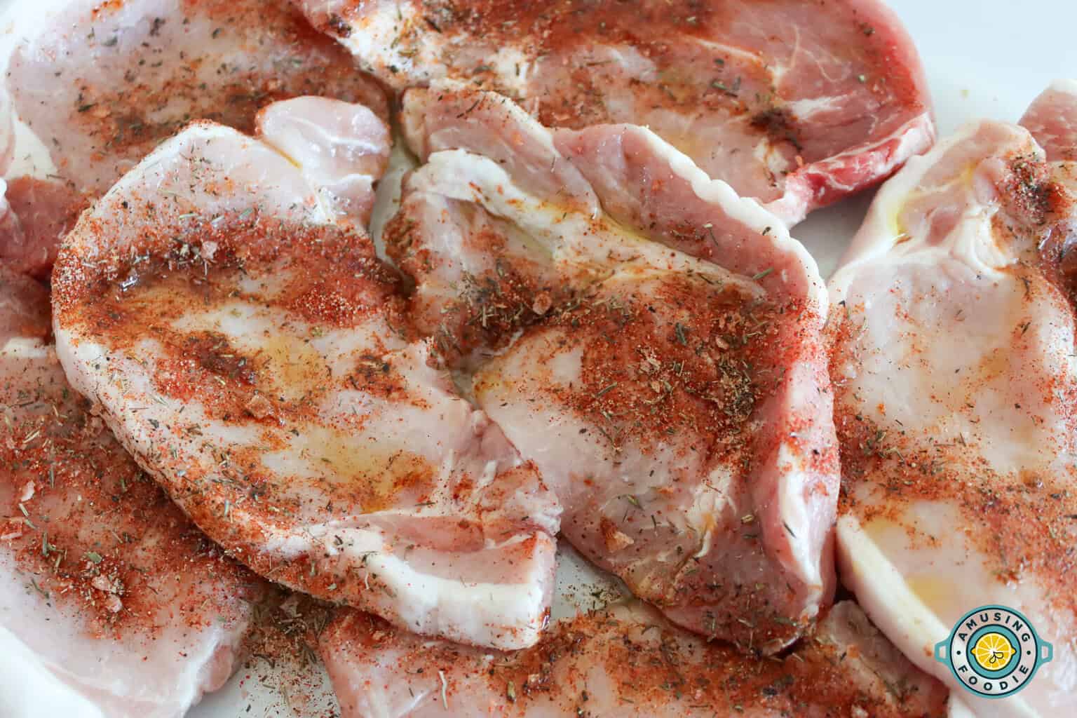 Raw seasoned pork chops ready