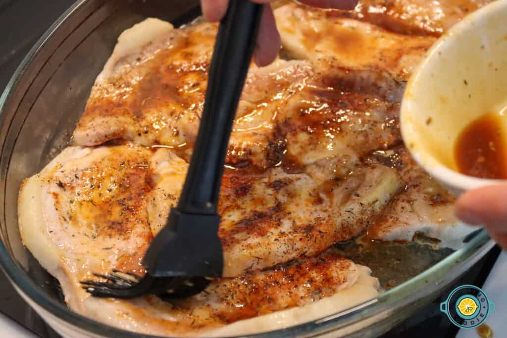 Brushing marinade on pork chops