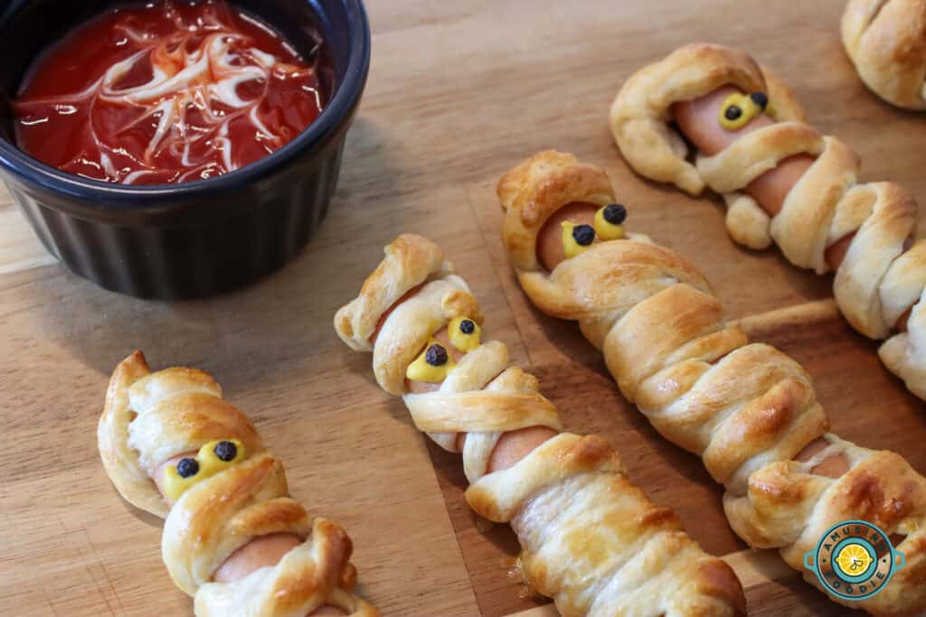 Mummy hotdogs with ketchup on side