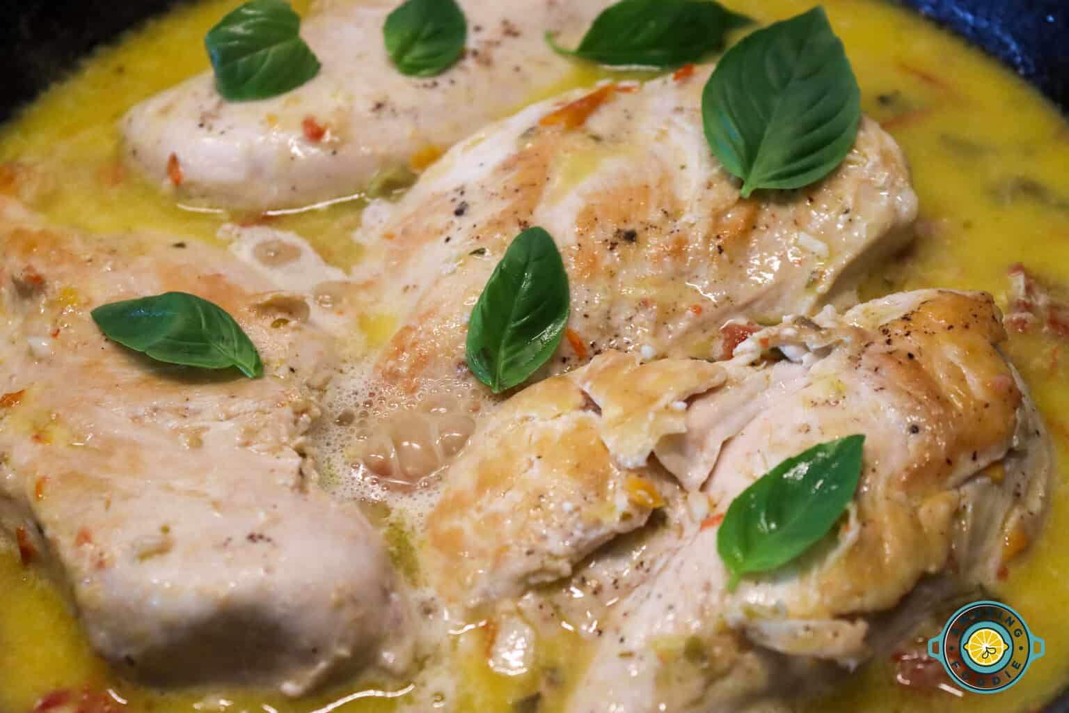 Simmering chicken closeup with basil
