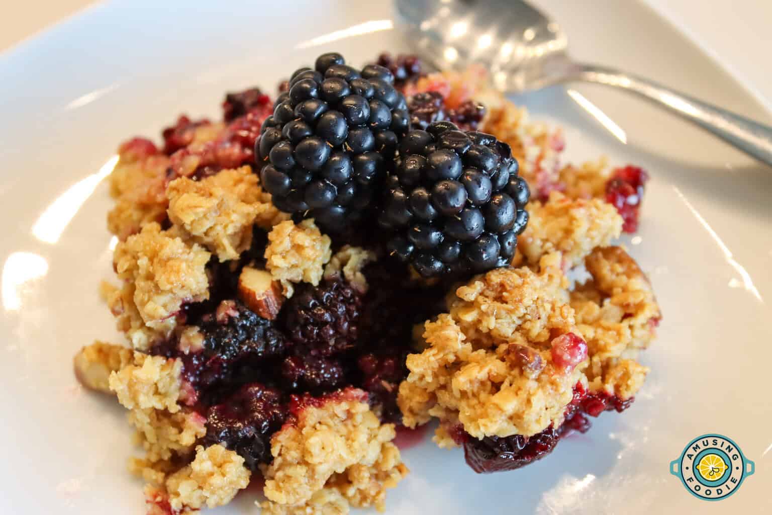 Blackberry Crumble on plate with spoon closeup