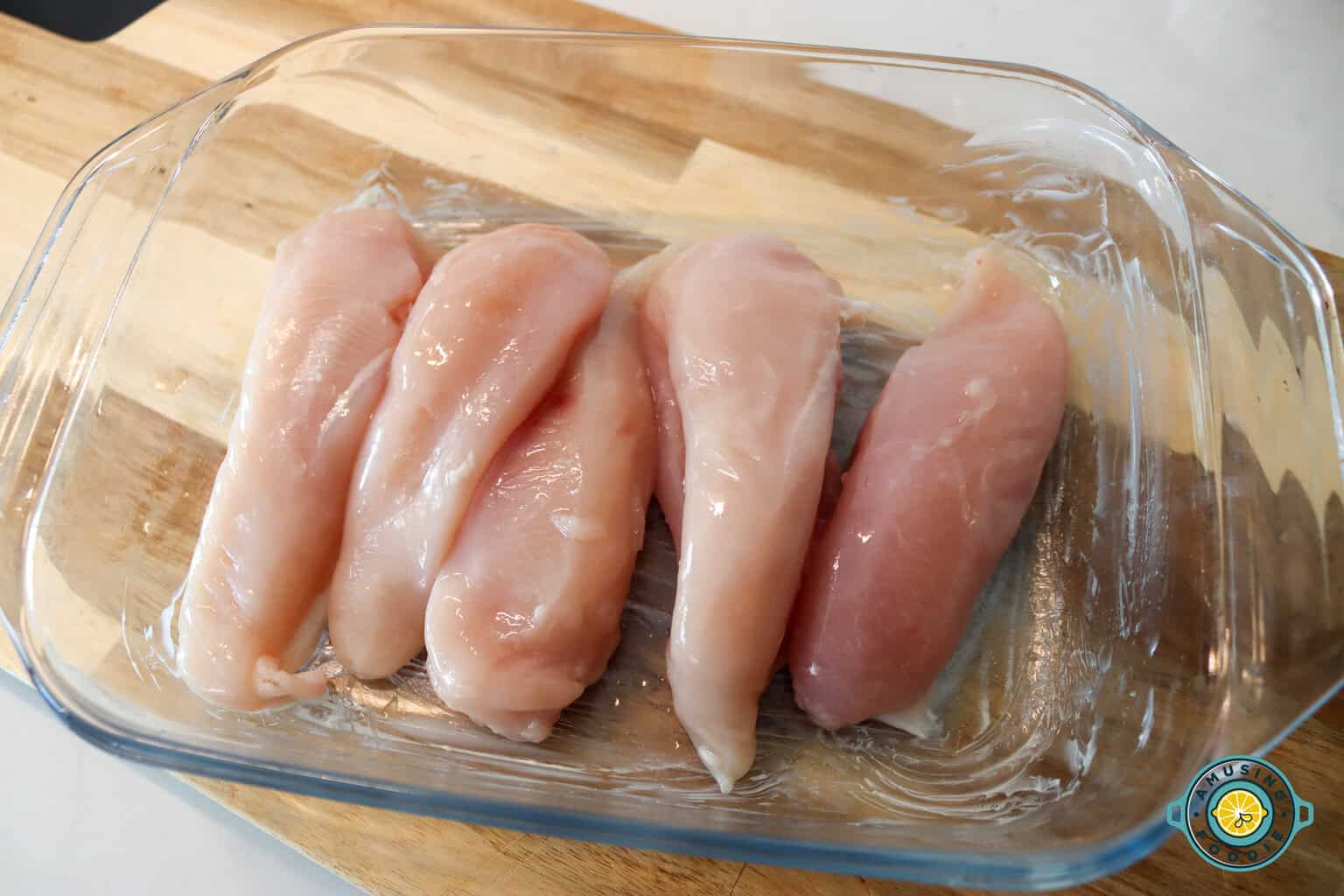 Raw chicken in a glass tray