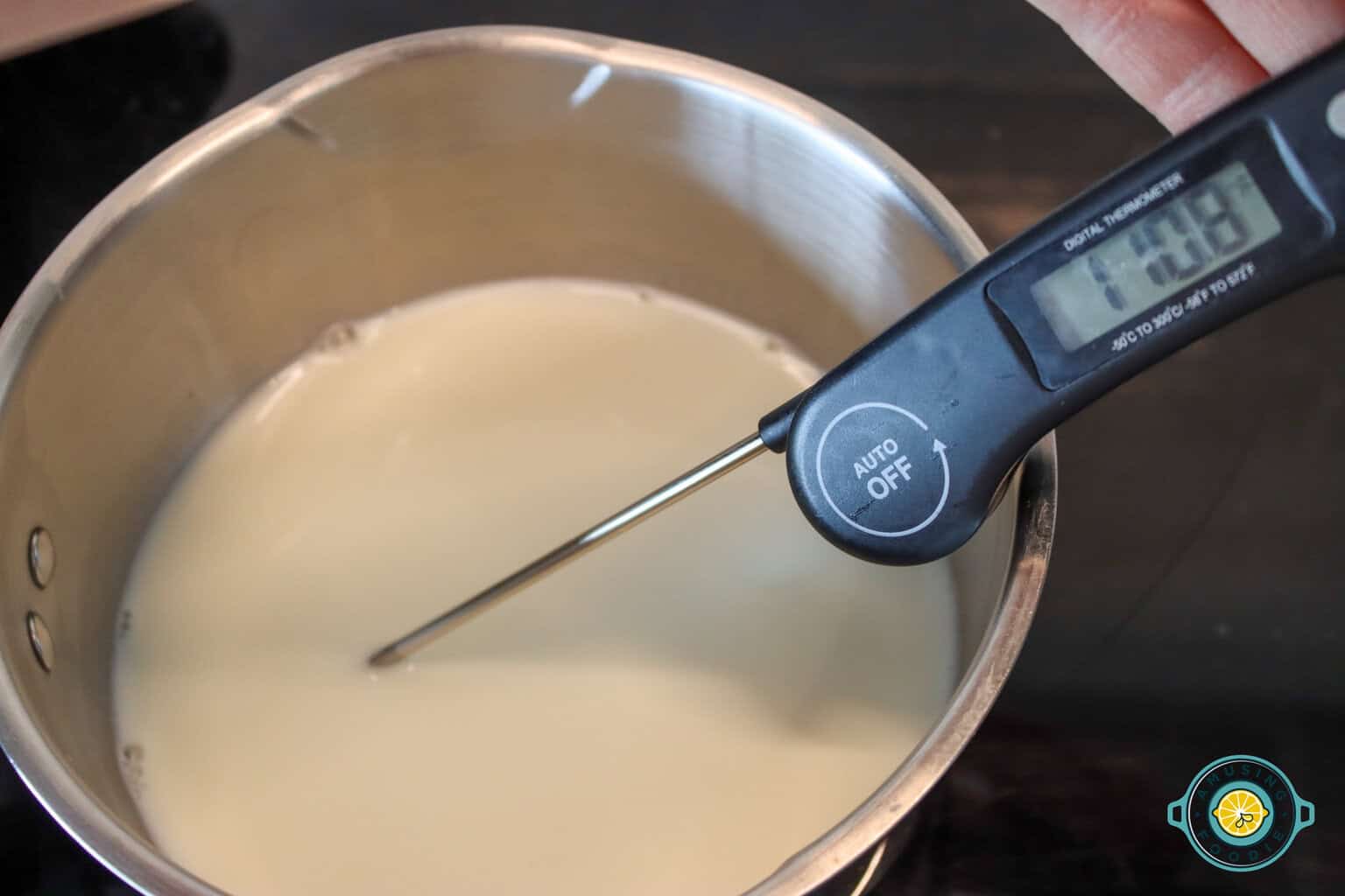 Boiling milk with food thermometer