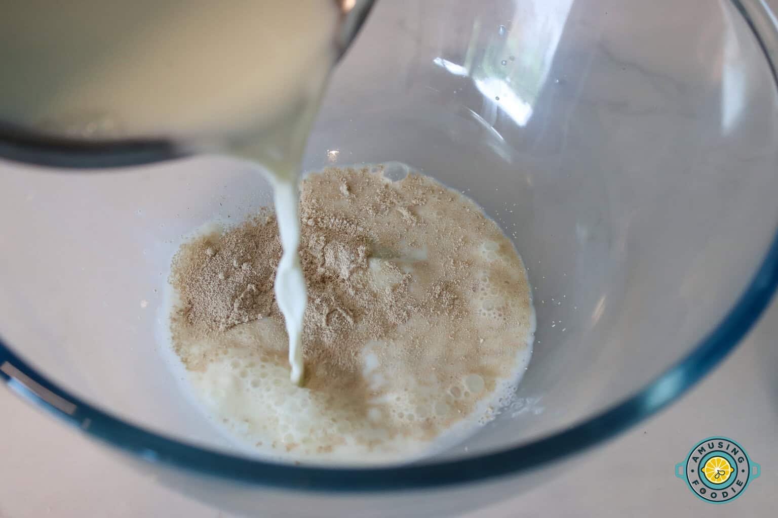 Milk being poured on flour