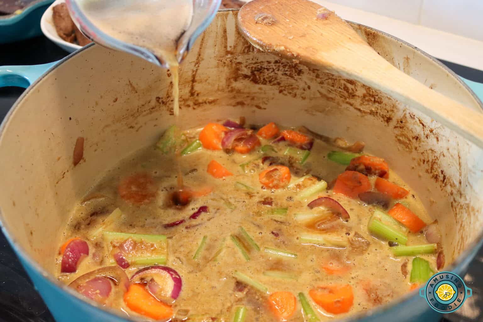 Pouring beef stock on stew