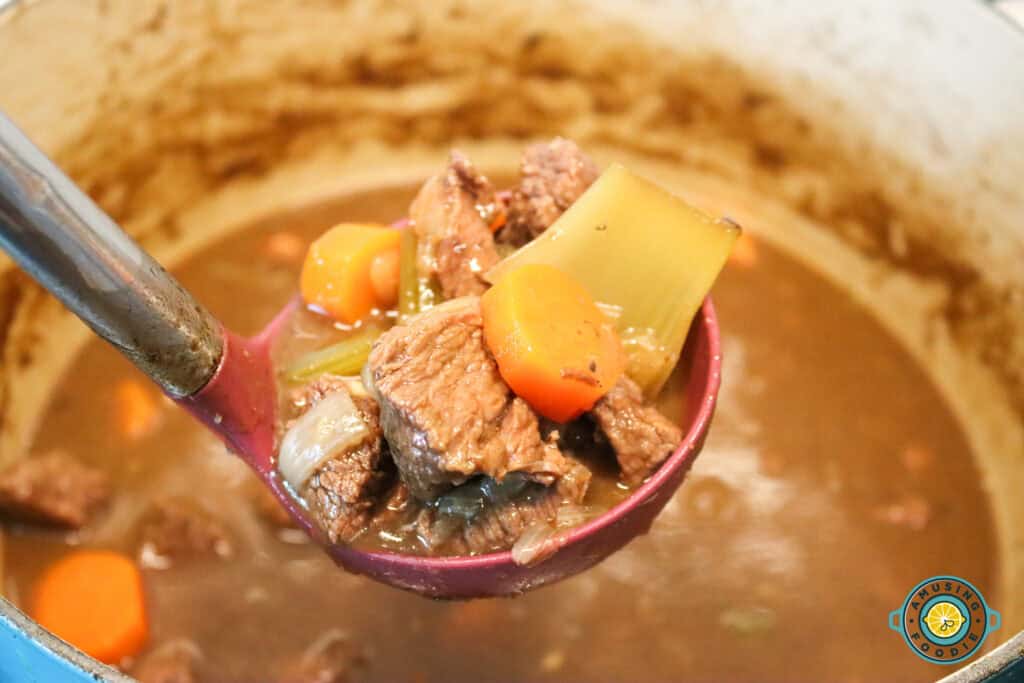 ladle filled with hearty Irish Guinness beef stew
