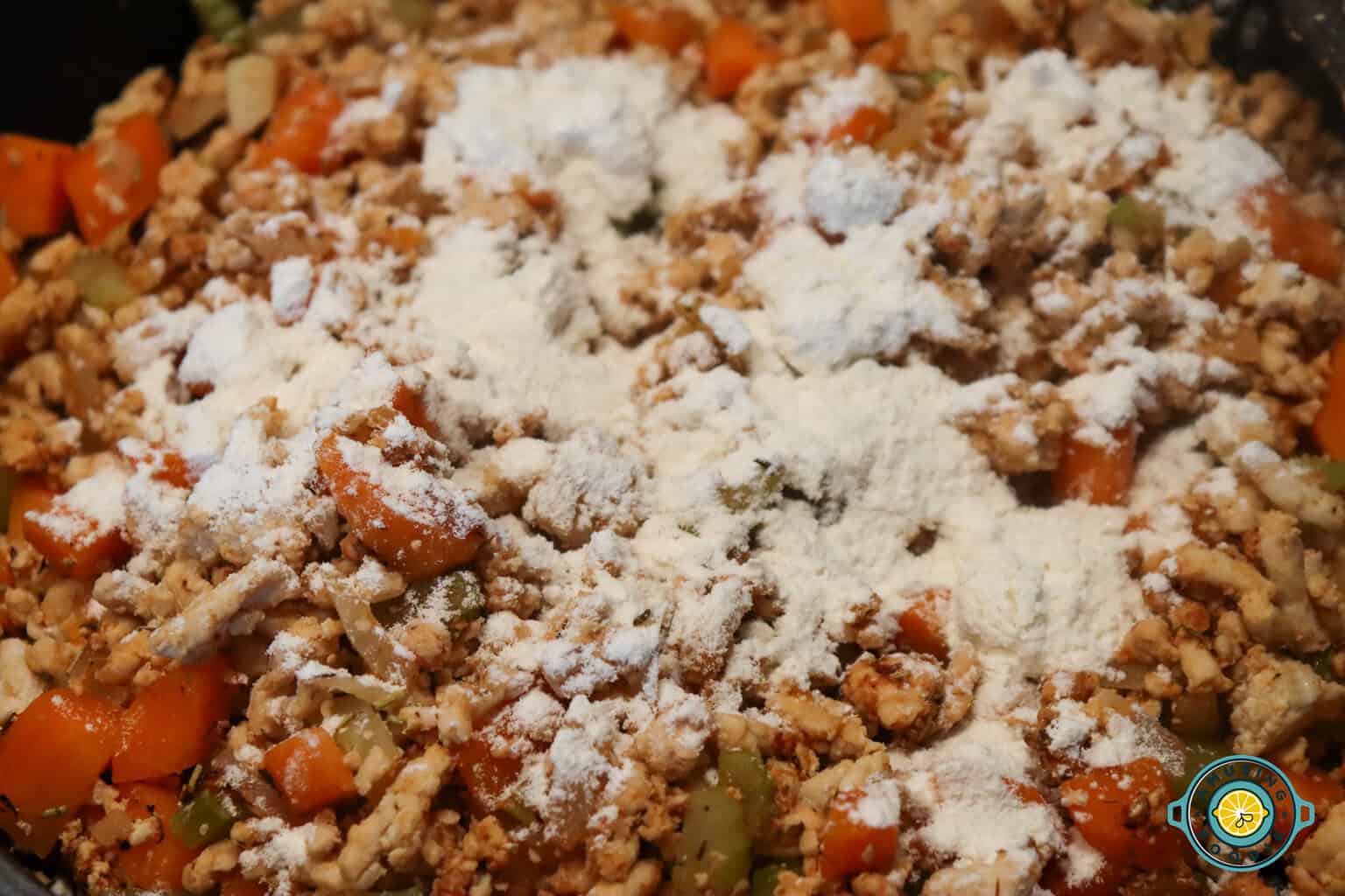 adding flour on ground turkey mixture
