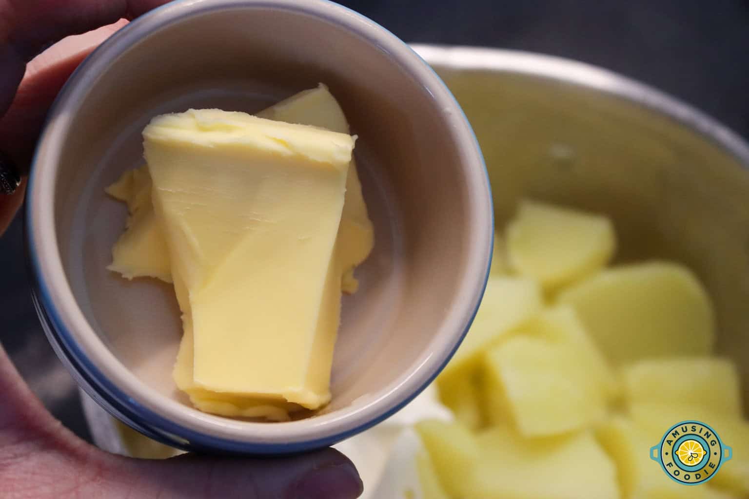 adding butter to mashed potato